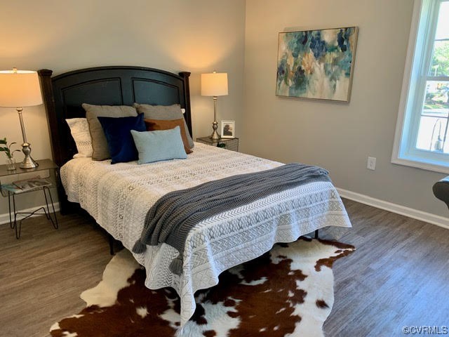 1504 Ewing Park Loop, Unit 203 Midlothian, VA 23113 - Photo 12 of 17 a bedroom with a bed and wooden floor