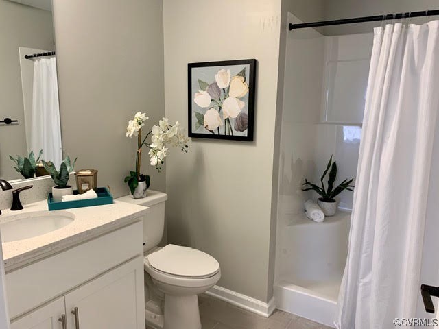 1504 Ewing Park Loop, Unit 203 Midlothian, VA 23113 - Photo 15 of 17 a bathroom with a sink a toilet and a mirror