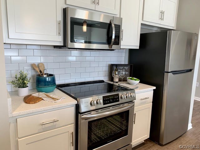 1504 Ewing Park Loop, Unit 203 Midlothian, VA 23113 - Photo 6 of 17 a kitchen with a stove and a microwave