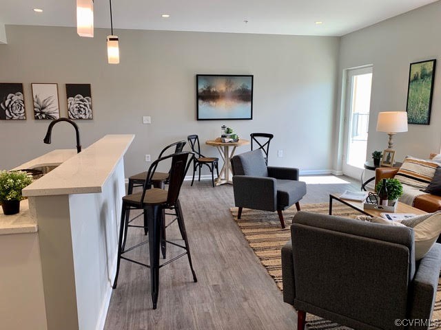 1504 Ewing Park Loop, Unit 203 Midlothian, VA 23113 - Photo 8 of 17 a work room with furniture and wooden floor