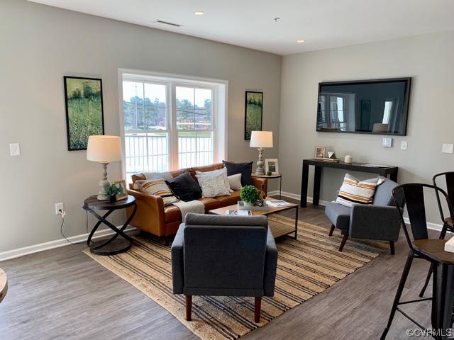 1504 Ewing Park Loop, Unit 203 Midlothian, VA 23113 - Photo 9 of 17 a living room with furniture a flat screen tv and a large window