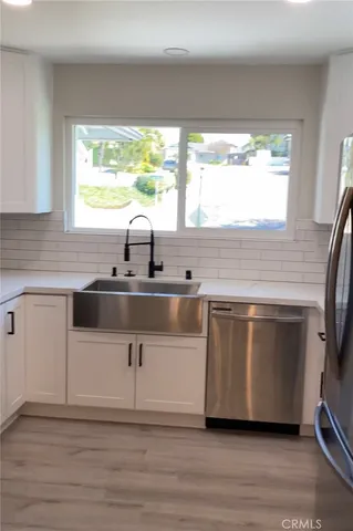 a kitchen with kitchen island a sink a stove and a window