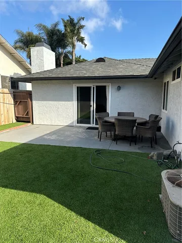 a view of a house with backyard sitting area and garden