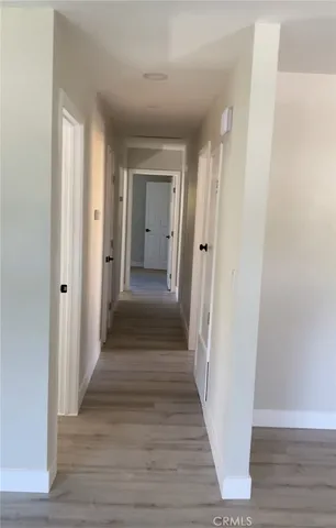 a view of a hallway with wooden floor