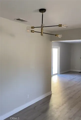 a view of a room with wooden floor and windows