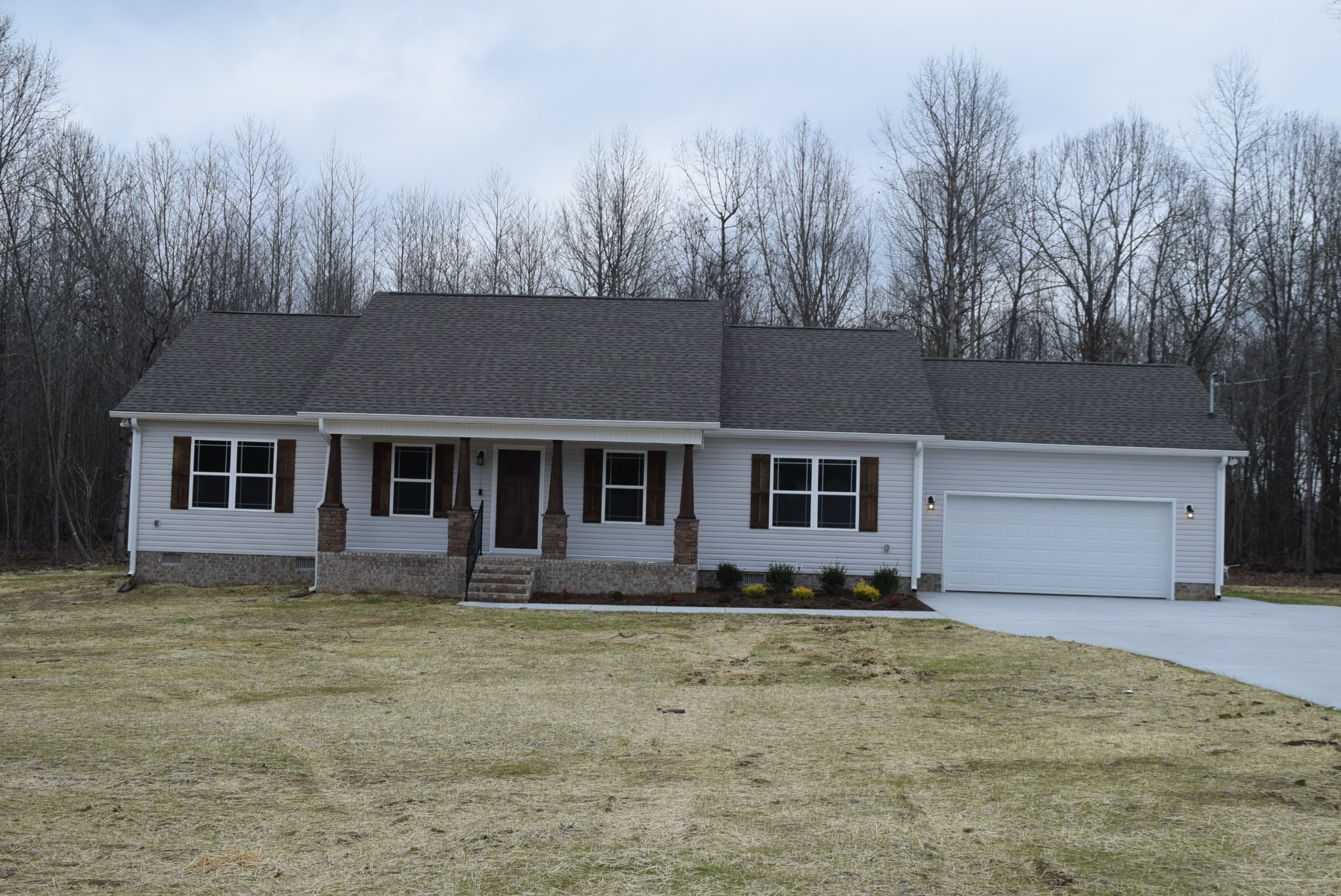213 Ballard Road Manchester, TN 37355 - Photo 1 of 10 a front view of a house with a garden