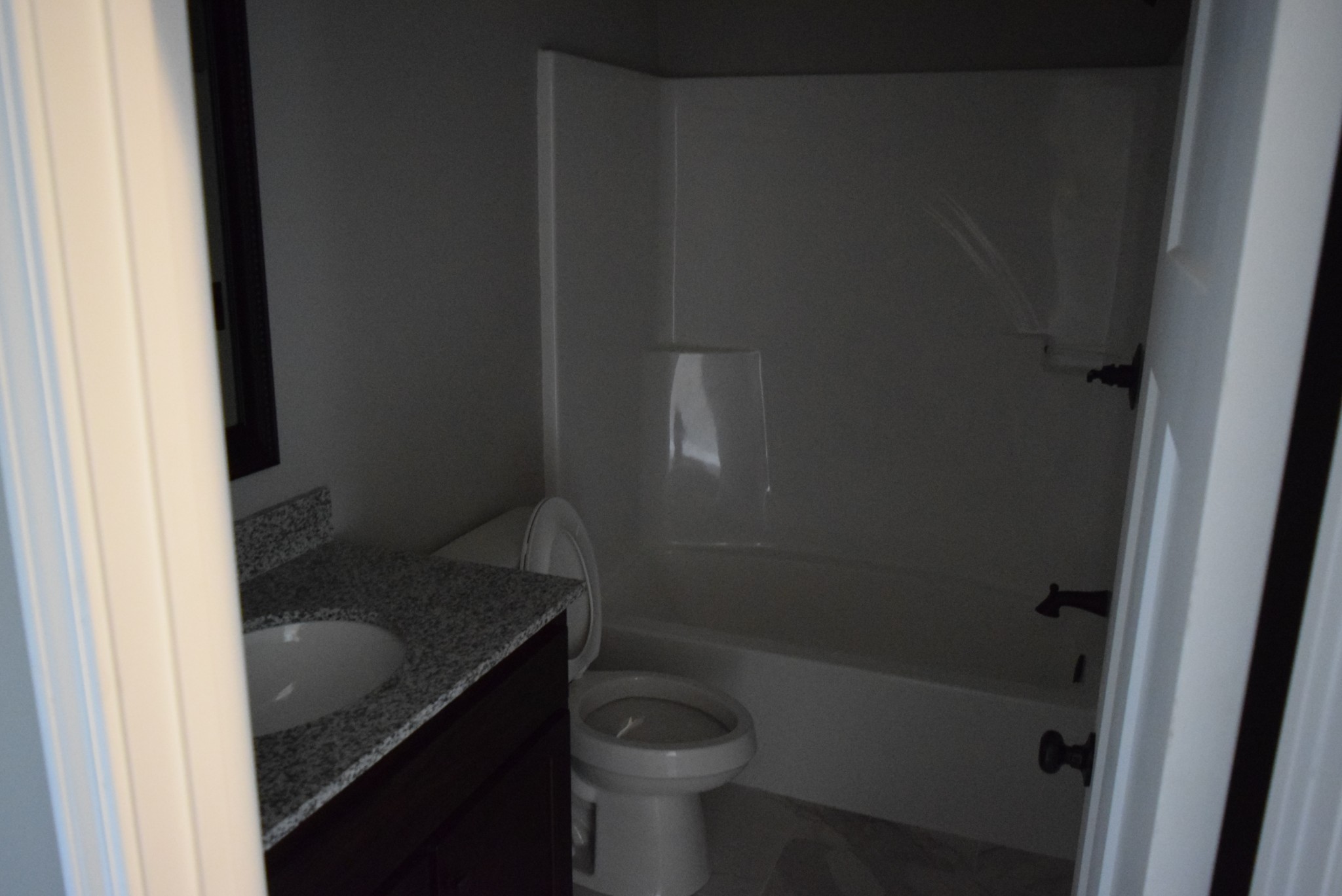 213 Ballard Road Manchester, TN 37355 - Photo 3 of 10 a bathroom with a granite countertop toilet and a sink