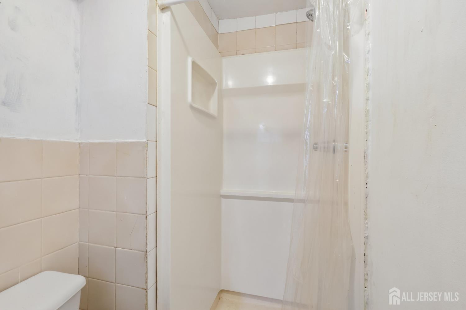 36 Henry Street Edison, NJ 08820 - Photo 36 of 42 a bathroom with a shower and toilet