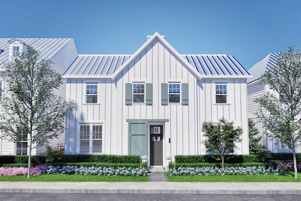 Modern farmhouse-style exterior featuring vertical board siding and a metal roof
