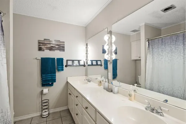 a bathroom with a double vanity sink and mirror