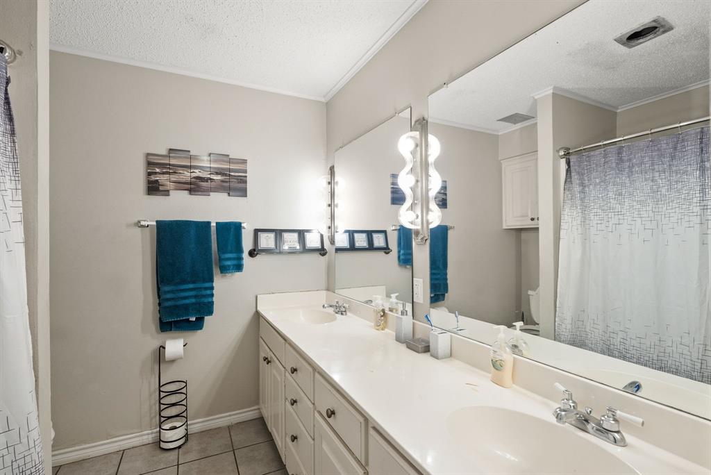 2103 Easy Street Tyler, TX 75703 - Photo 12 of 32 a bathroom with a double vanity sink and mirror