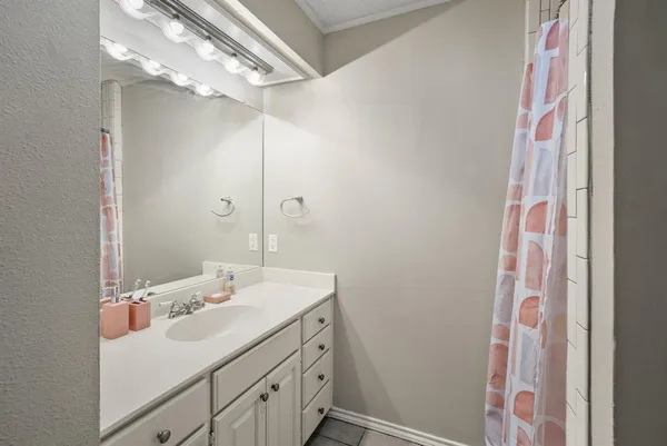 a bathroom with a sink vanity and a mirror