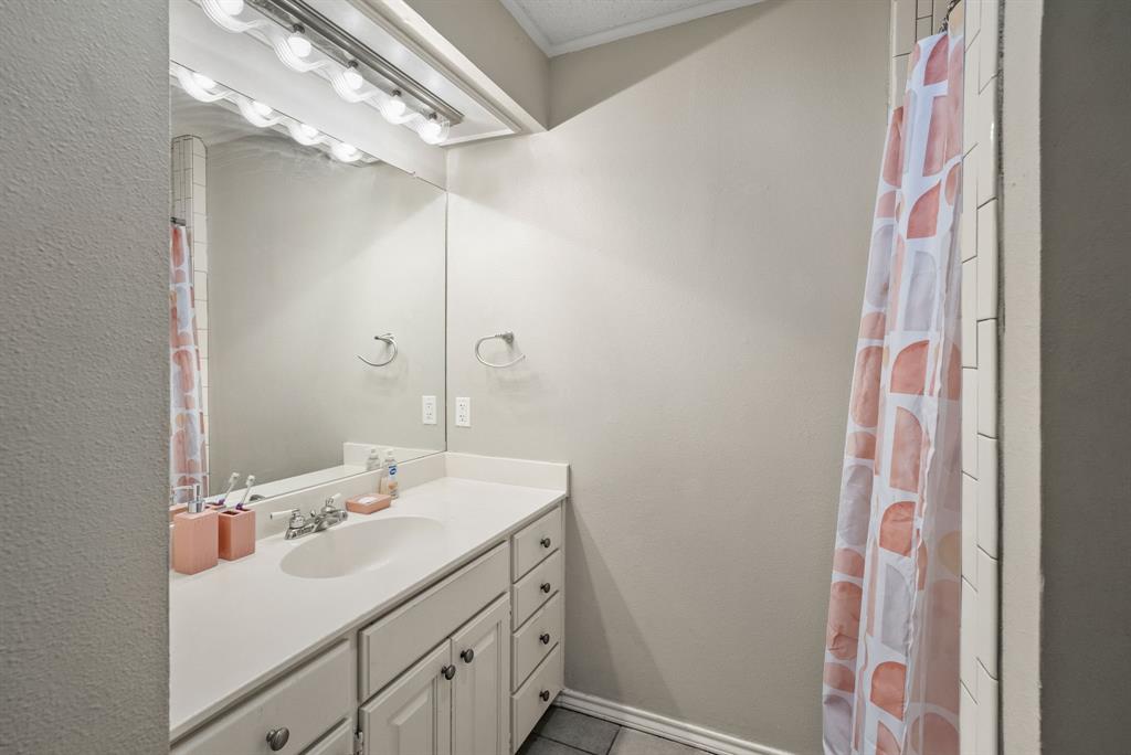 2103 Easy Street Tyler, TX 75703 - Photo 15 of 32 a bathroom with a sink vanity and a mirror