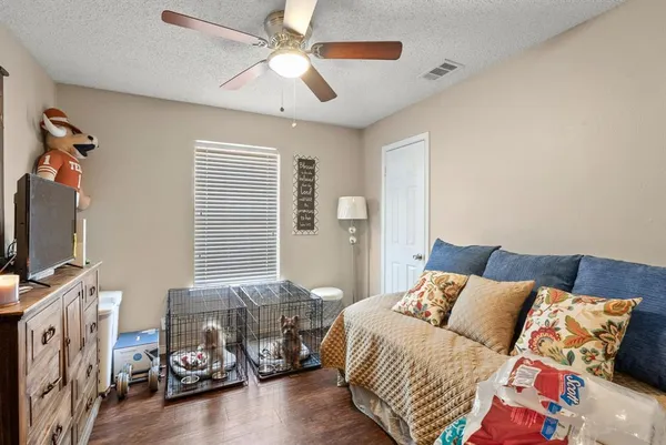 a bedroom with furniture and a flat screen tv