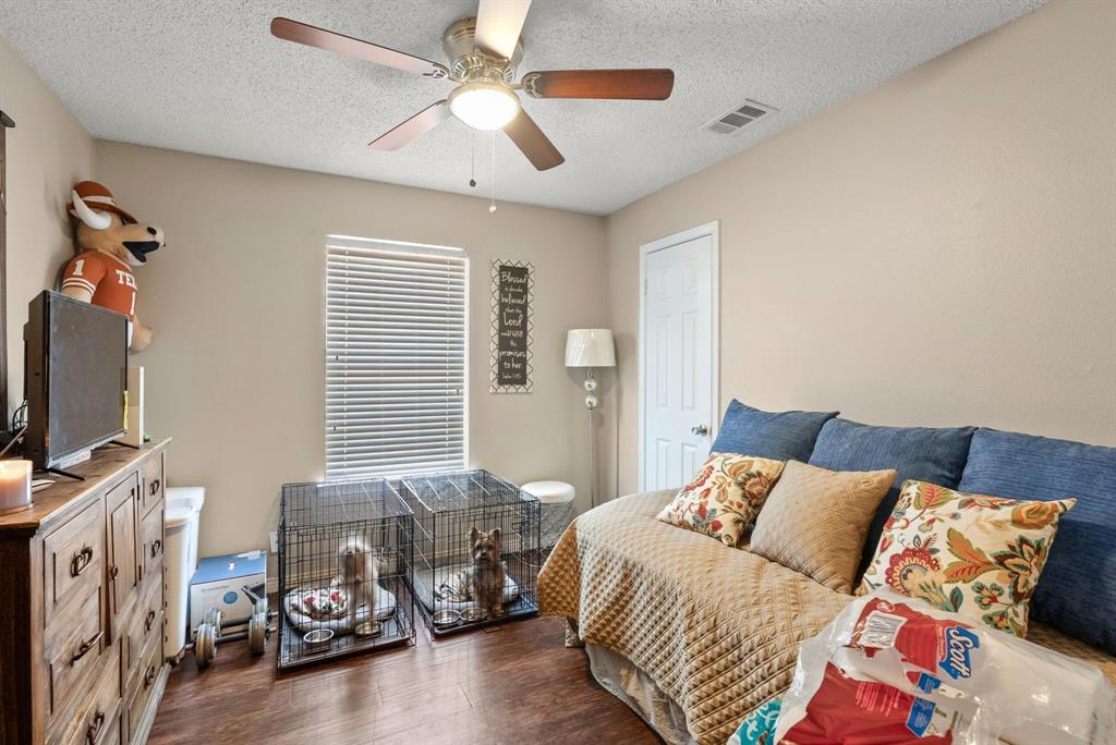 2103 Easy Street Tyler, TX 75703 - Photo 16 of 32 a bedroom with furniture and a flat screen tv