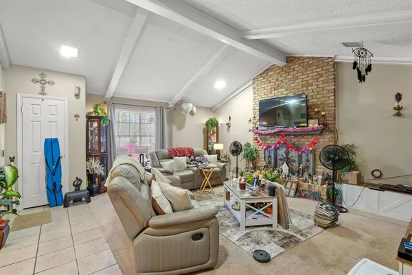 a living room with furniture gym equipment and a flat screen tv