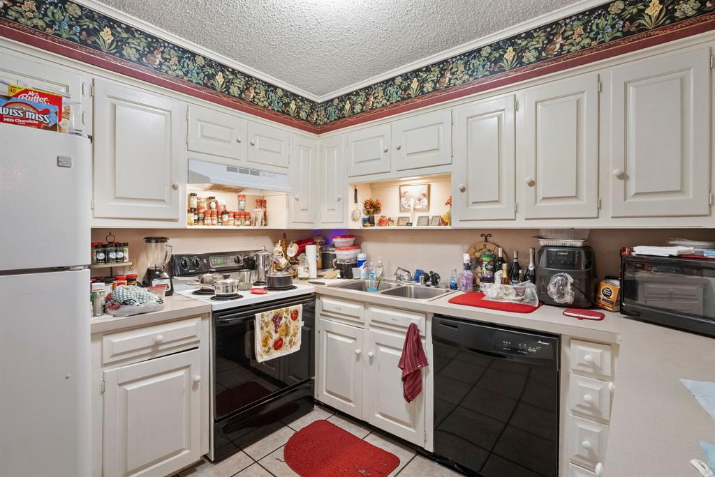 2103 Easy Street Tyler, TX 75703 - Photo 22 of 32 a kitchen with a stove top oven and cabinets