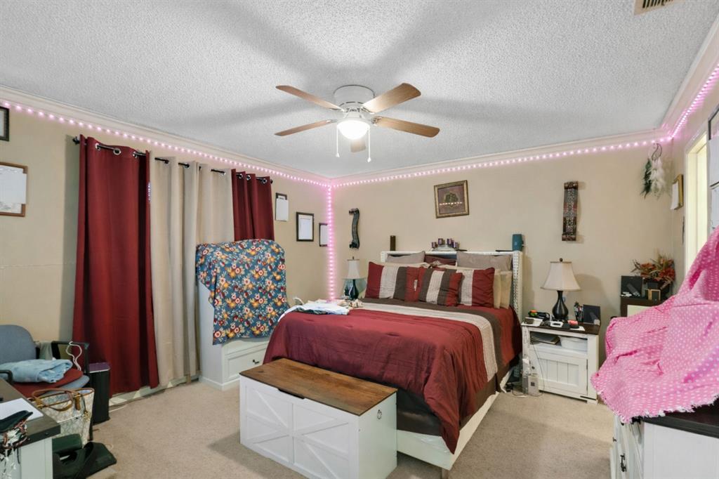 2103 Easy Street Tyler, TX 75703 - Photo 24 of 32 a bed room with a bed and a chair