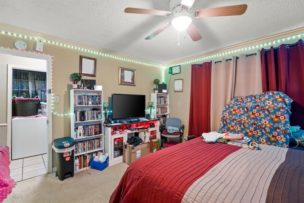 2103 Easy Street Tyler, TX 75703 - Photo 25 of 32 a bedroom with a bed and a flat screen tv
