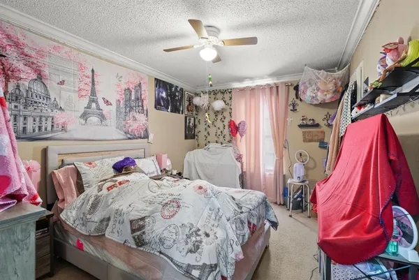 a bed sitting in a bedroom next to a lamp