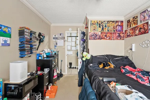 a bedroom with furniture and workout equipment