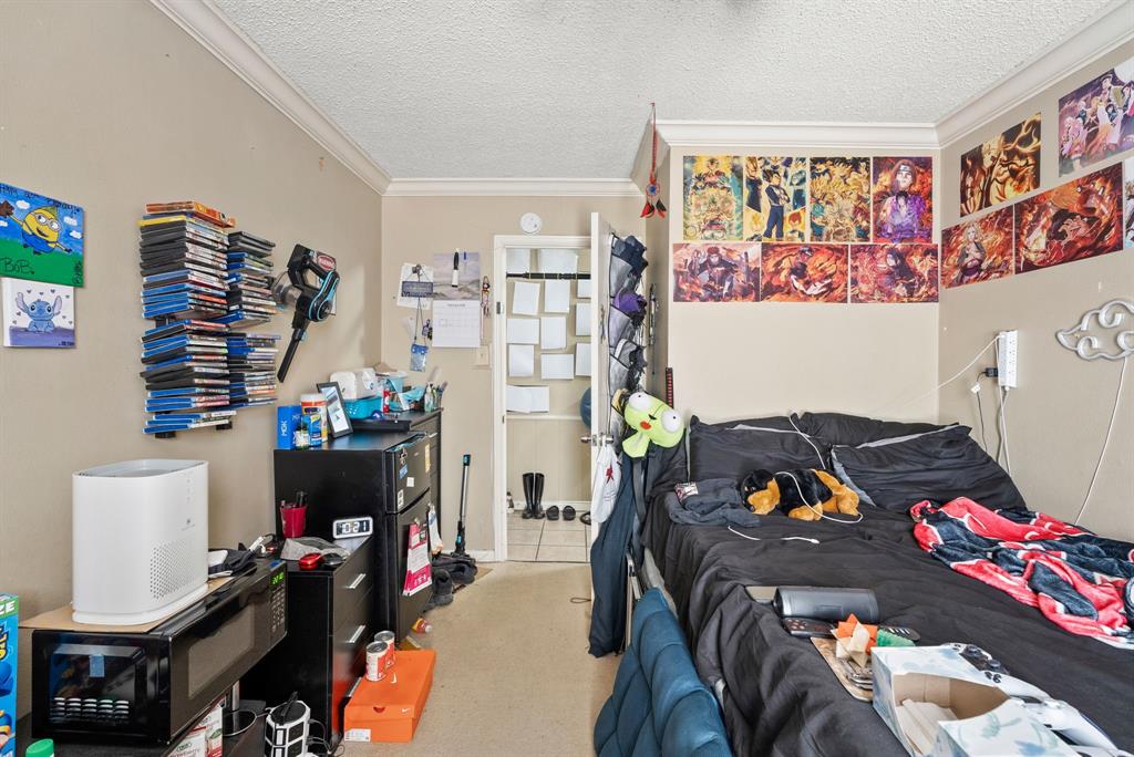 2103 Easy Street Tyler, TX 75703 - Photo 28 of 32 a bedroom with a bed and a couch