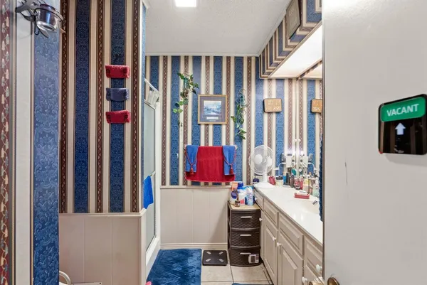 a bathroom with double vanity and a mirror
