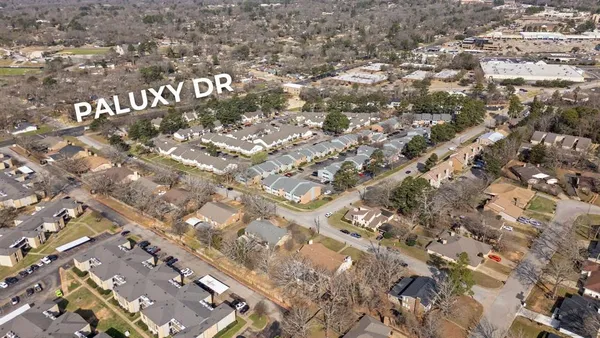 a view of residential houses with yard