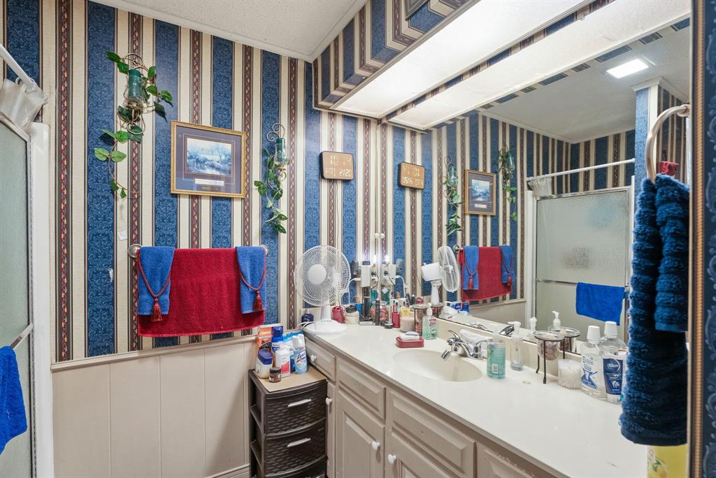 2103 Easy Street Tyler, TX 75703 - Photo 31 of 32 a bathroom with double vanity and a mirror