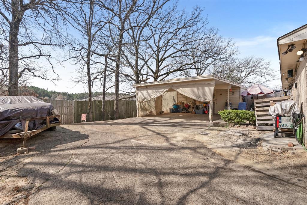2103 Easy Street Tyler, TX 75703 - Photo 32 of 32 a view of a house with a yard covered in snow