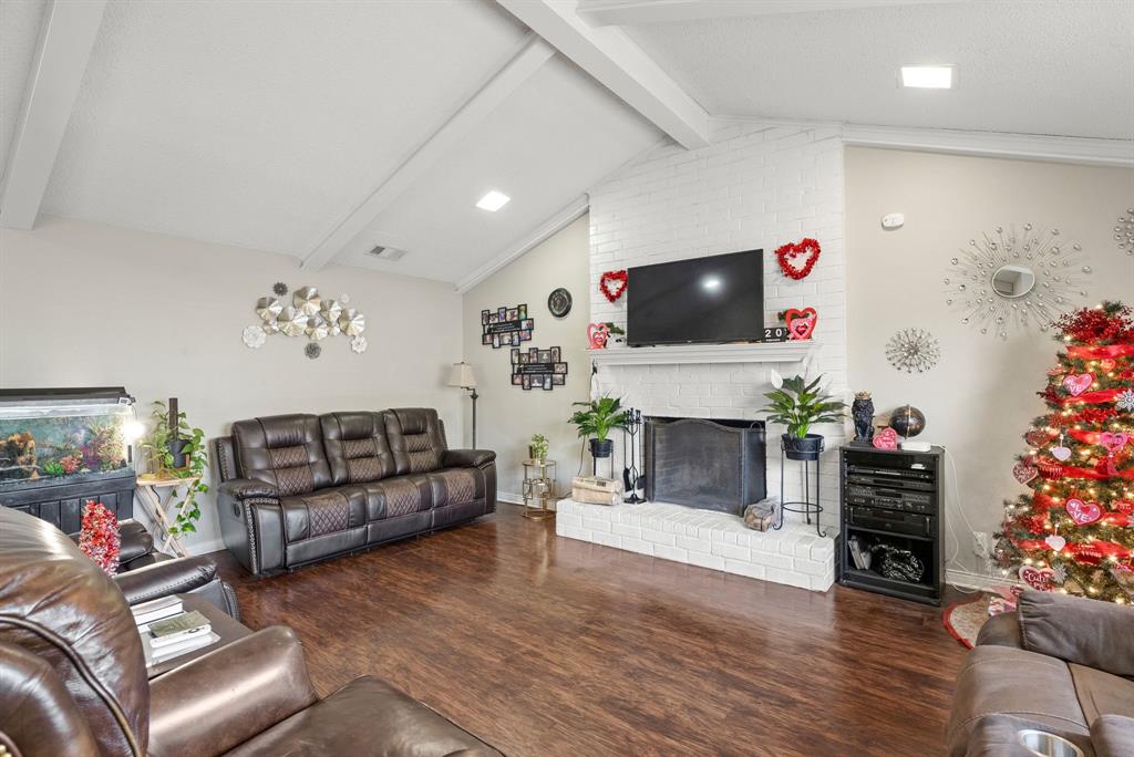 2103 Easy Street Tyler, TX 75703 - Photo 4 of 32 a living room with furniture a fireplace and a flat screen tv