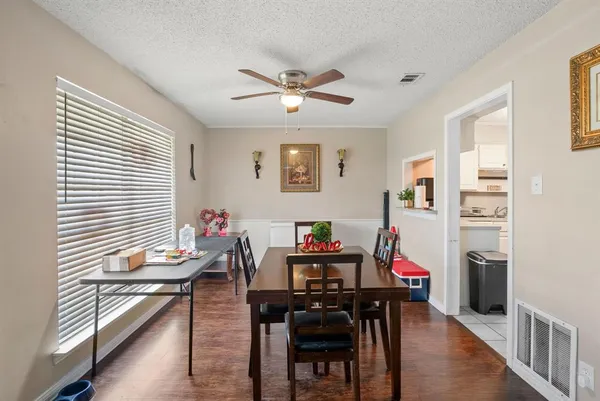 a view of a dining room with furniture and a window