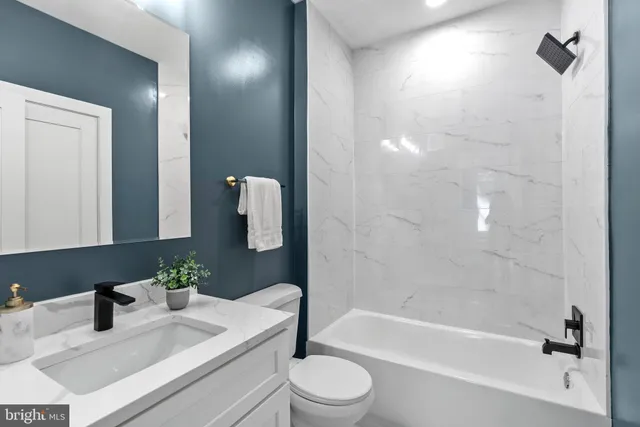 a bathroom with a sink a toilet and bathtub