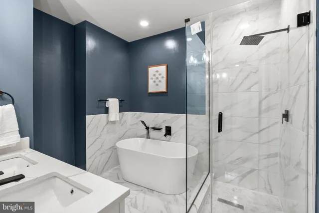 a bathroom with a bathtub and shower