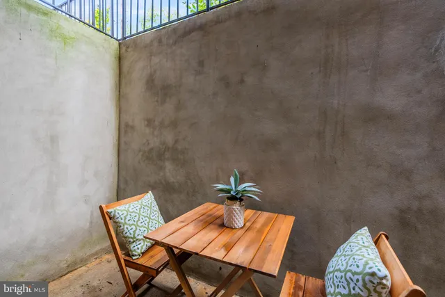 a view of a balcony dining area with furniture