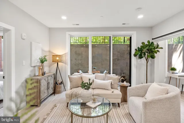 a living room with furniture and a large window