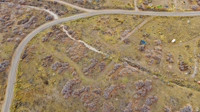 349 West Mountain View Road, Unit 349 Fairview, UT 84629 - Photo 12 of 26 Expansive aerial view of a natural landscape featuring a paved roadway, secondary unpaved paths, scattered shrubbery, and open terrain