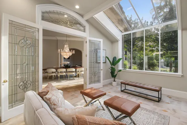 a view of a dining room with furniture a chandelier and wooden floor