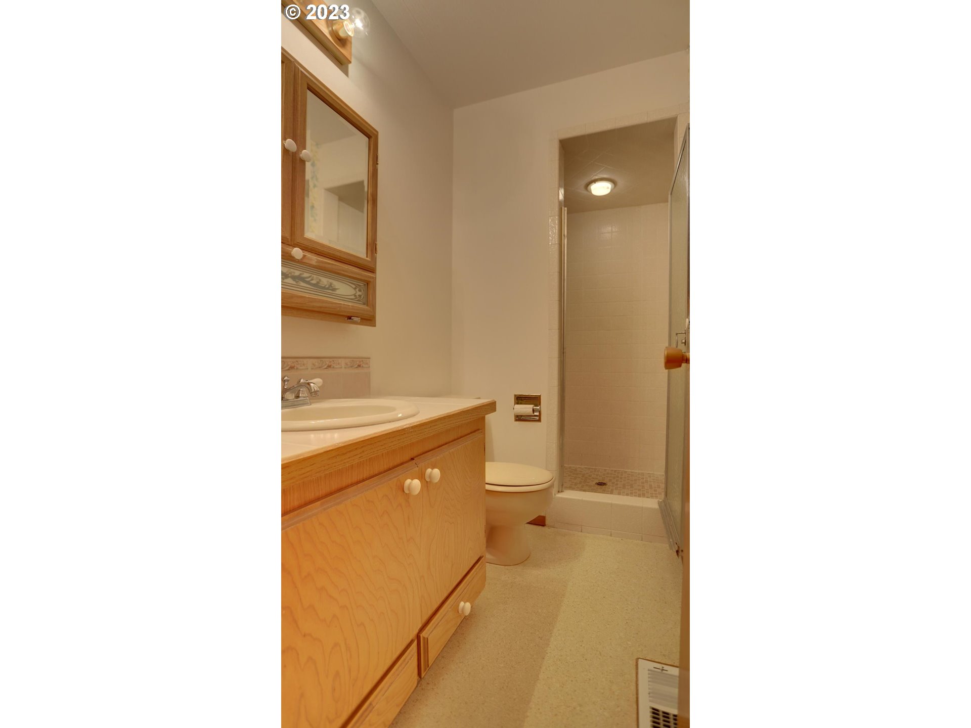 21985 Southeast Borges Road Damascus, OR 97089 - Photo 13 of 24 a bathroom with a sink a toilet and mirror