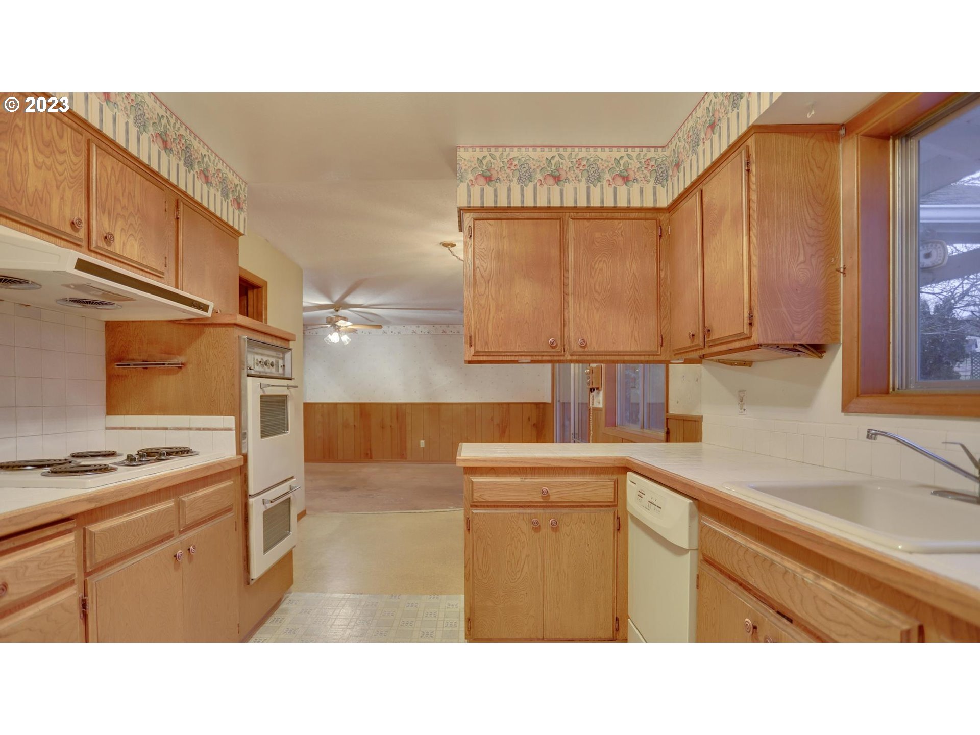 21985 Southeast Borges Road Damascus, OR 97089 - Photo 6 of 24 a kitchen with a sink a stove and cabinets