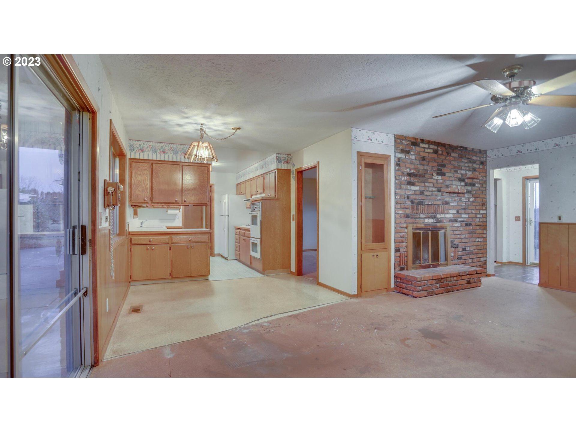 21985 Southeast Borges Road Damascus, OR 97089 - Photo 7 of 24 a room with kitchen view and a chandelier