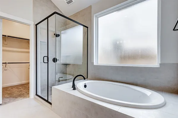 a bathroom with a tub and a shower