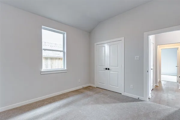 an empty room with windows and closet