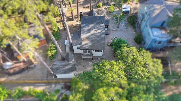 an aerial view of a house with a yard and potted plants