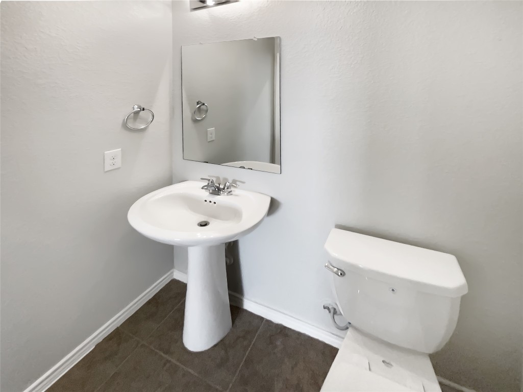 5709 Southerner Way Austin, TX 78747 - Photo 14 of 26 Bathroom featuring dark tile patterned floors and baseboards