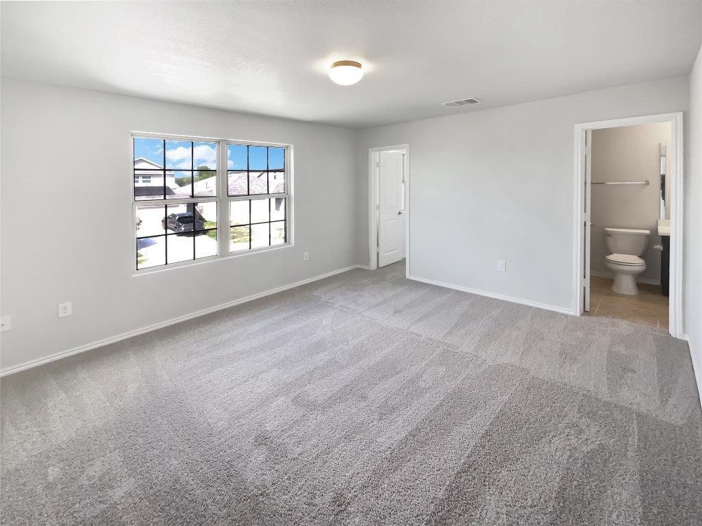 5709 Southerner Way Austin, TX 78747 - Photo 20 of 26 Unfurnished bedroom featuring light colored carpet and ensuite bath