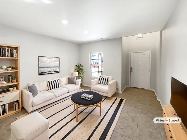 a living room with furniture rug and window