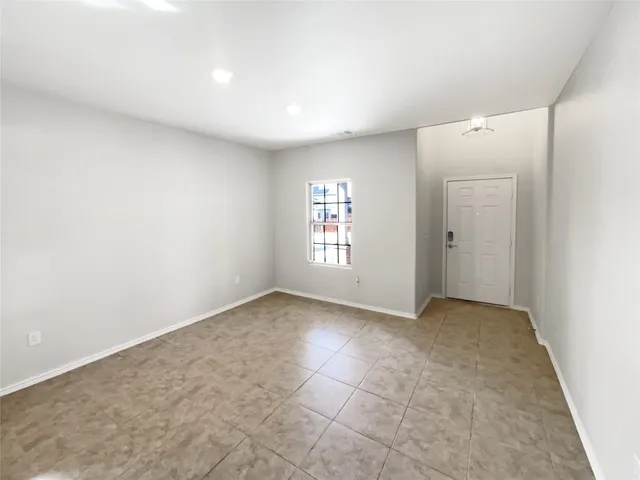 an empty room with windows and closet