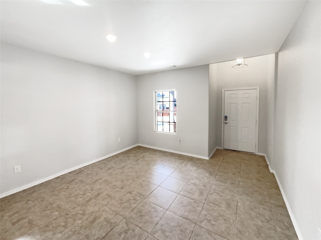 5709 Southerner Way Austin, TX 78747 - Photo 3 of 26 Unfurnished room with light tile patterned flooring and recessed lighting