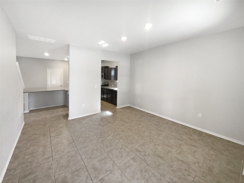 5709 Southerner Way Austin, TX 78747 - Photo 9 of 26 Unfurnished room featuring light tile patterned floors and recessed lighting